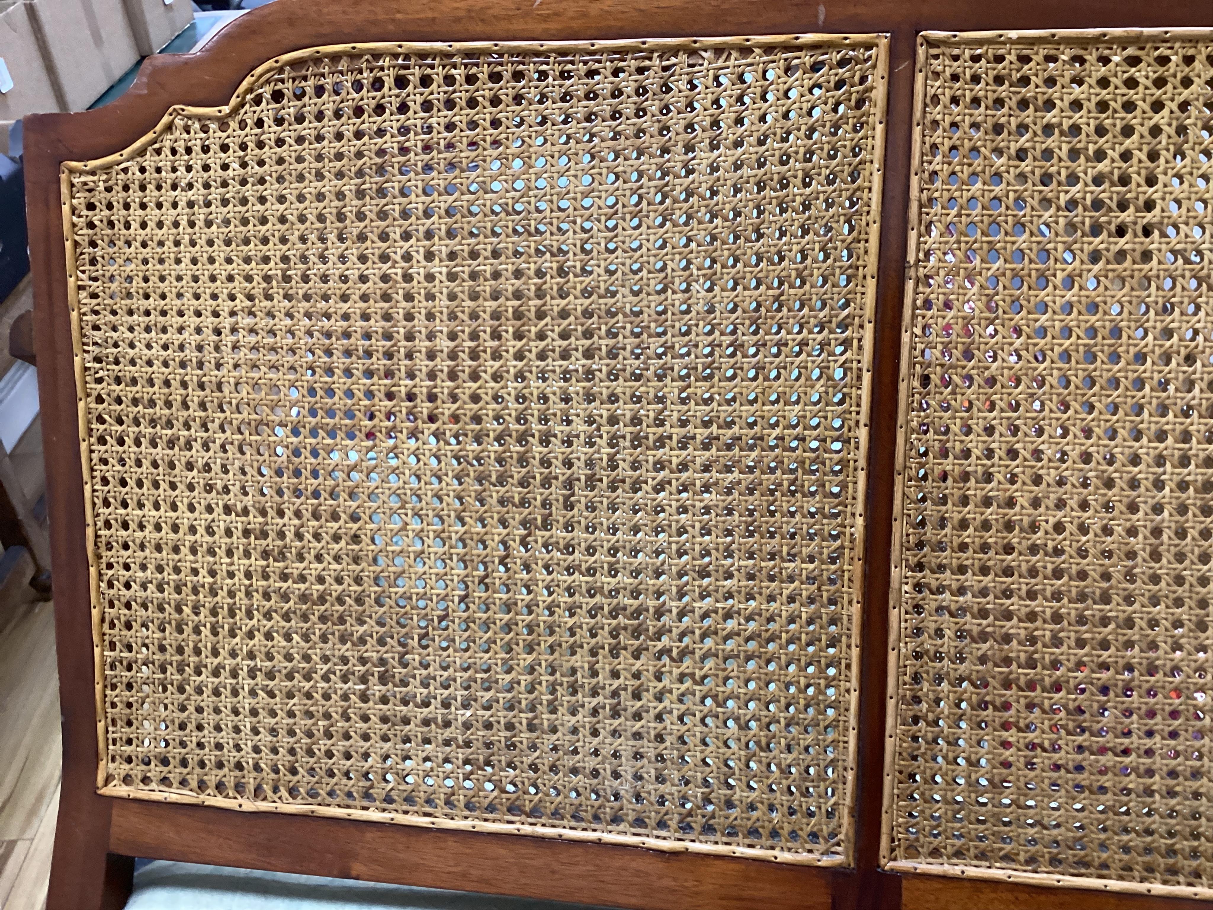 A mahogany double caned bergere settee with loose cushion seat and back, width 178cm, depth 78cm, height 87cm